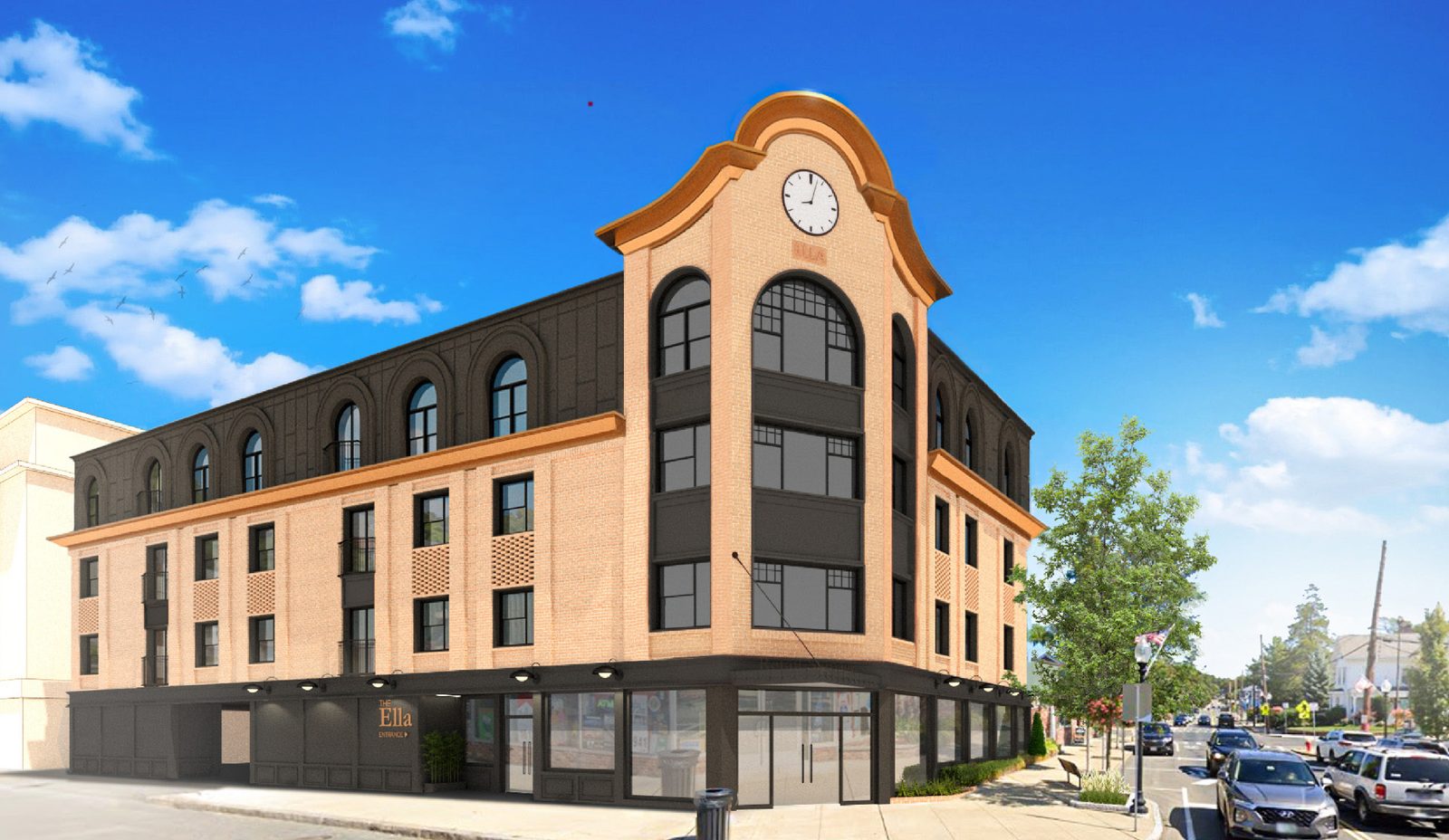 Corner mixed-use building with a clock tower and ground-floor commercial units