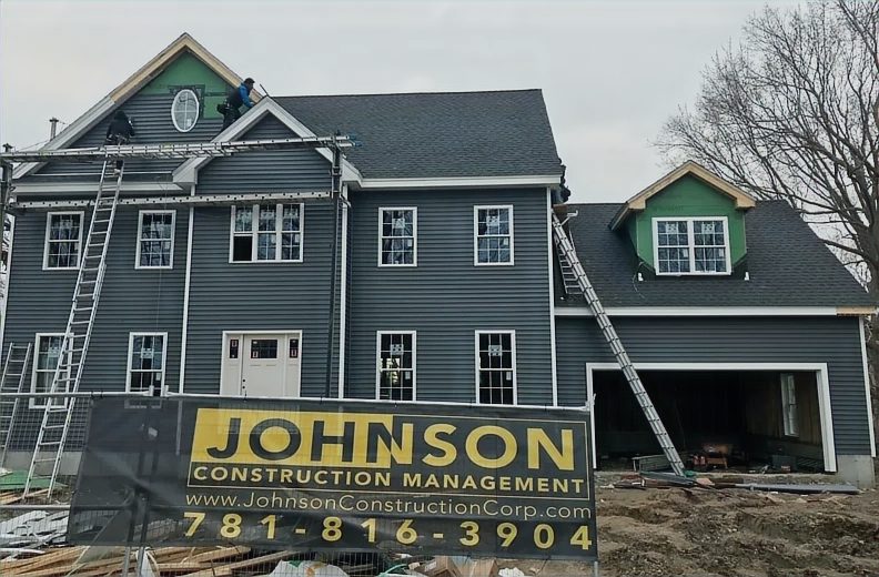 Single residence under construction with a Johnson Construction Management site sign