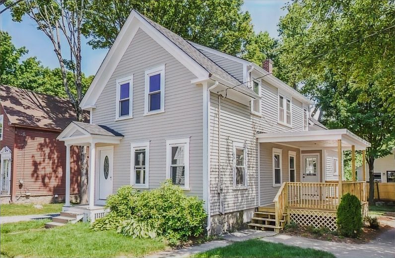 Restored white clapboard house with a covered porch